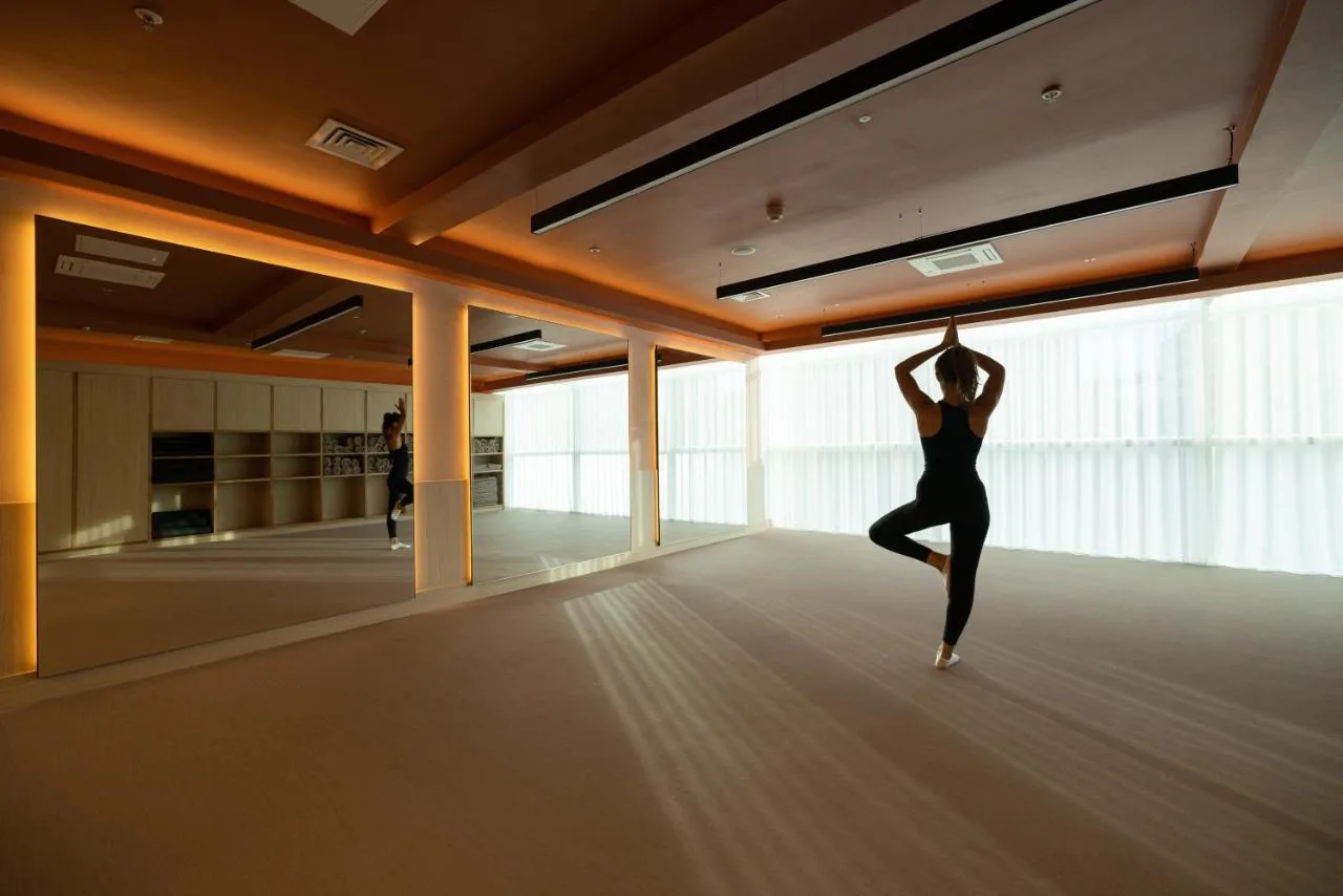 a woman doing a yoga pose in a room at The Lowry Hotel Manchester in Manchester