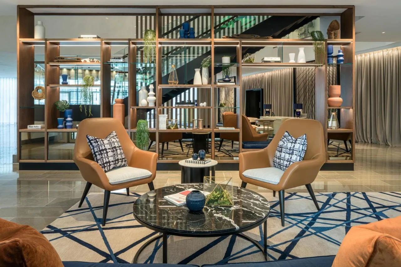 a living room with chairs and a table at The Lowry Hotel Manchester in Manchester